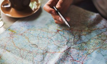 Man making travel and budgeting plans on a map
